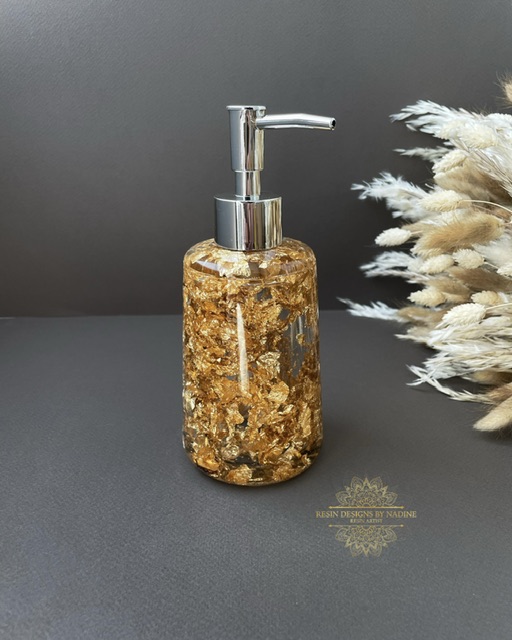 Gold soap dispenser with a silver pump