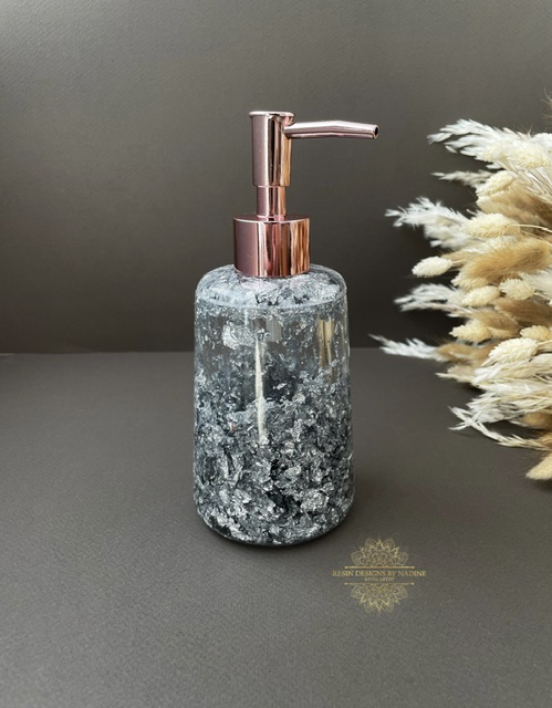 Silver soap dispenser with a pink pump