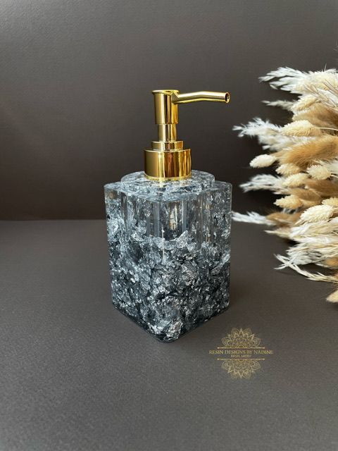 Silver soap dispenser with a gold pump